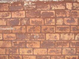 mur de briques rouges texture grunge background avec coins vignetted, peut être utilisé pour la décoration intérieure photo