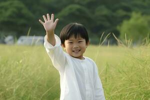 asiatique garçon agitant mains. produire ai photo