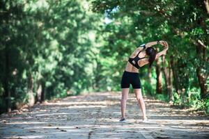 jeune femme fitness étirement des jambes avant de courir. photo