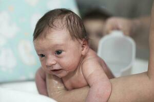 bébé nouveau-né prenant son premier bain photo