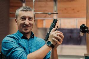 une homme les pratiques tournage une pistolet dans une tournage intervalle tandis que portant protecteur écouteurs photo