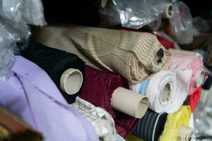 intérieur de un industriel entrepôt avec en tissu Rouleaux échantillons. petit affaires textile coloré entrepôt. photo