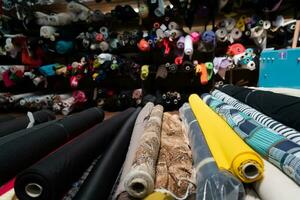 intérieur de un industriel entrepôt avec en tissu Rouleaux échantillons. petit affaires textile coloré entrepôt. photo