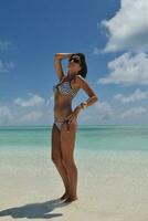 belle jeune femme sur la plage s'amuser et se détendre photo