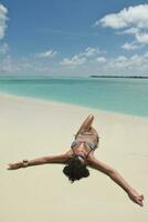 belle jeune femme sur la plage s'amuser et se détendre photo