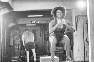l'athlète féminine noire effectue des sauts de boîte au gymnase photo