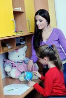 maman et fille faisant leurs devoirs à la maison photo