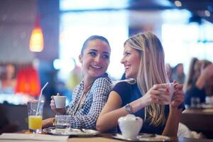 les filles prennent une tasse de café au restaurant photo