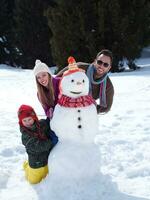 famille heureuse, confection, bonhomme de neige photo