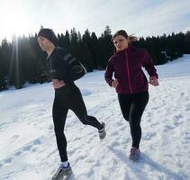 couple faisant du jogging dehors sur la neige photo