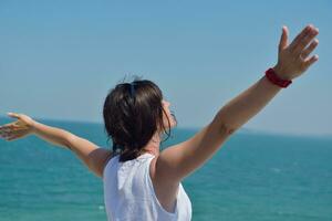 heureuse jeune femme avec les bras écartés vers le ciel photo