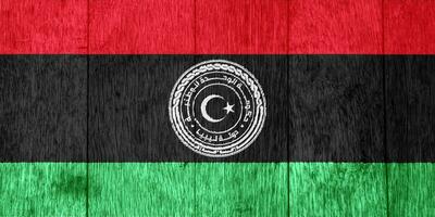 drapeau et manteau de bras de Etat de Libye sur une texturé Contexte. concept collage. photo