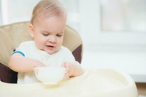 enfant mange bouillie mains de le assiette photo