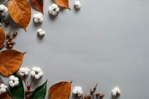 Orange feuilles et blanc fleurs sur une gris arrière-plan, automnal éléments pour tomber saison, ai généré photo