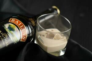 Kyiv, Ukraine - mai 4, 2022 Crème de whisky original de l'alcool bouteille sur en bois table avec noir en tissu photo