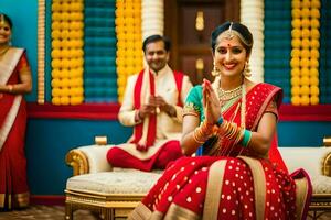 une la mariée dans rouge et or sari séance sur une canapé. généré par ai photo