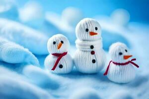 Trois bonhommes de neige sont séance sur une bleu couverture. généré par ai photo