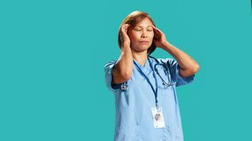 fatigué infirmière Souffrance de migraine douleur après fatigant journée à travail. hôpital ouvrier isolé plus de studio Contexte affecté par pénible mal de crâne pendant exigeant emploi changement, proche en haut photo