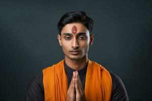 une photo de une Beau Jeune Indien homme avec le sien mains plié dans prière orienté vers le caméra, ai génératif