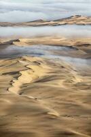 un aérien vue plus de le vaste le sable dunes cette faire en haut le génial le sable mer dans namibie. photo