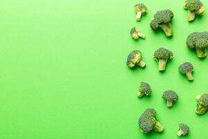 Haut vue Frais vert brocoli légume sur coloré Contexte. brocoli chou tête en bonne santé ou végétarien nourriture concept. plat poser. copie espace photo