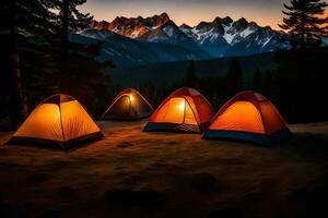 Trois tentes sont allumé en haut à nuit dans le montagnes. généré par ai photo