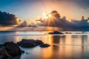 le coucher du soleil plus de le océan avec des nuages et rochers. généré par ai photo