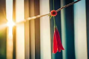 une rouge fleur pendaison de une fil. généré par ai photo