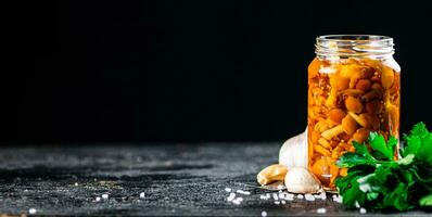 mariné champignons avec une verre pot avec persil et Ail. photo