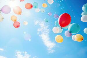 multicolore des ballons avec hélium sur une bleu ciel photo