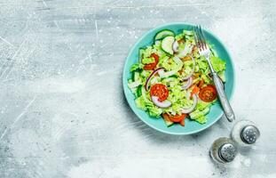 légume salade. salade de concombres, tomates et rouge oignons avec épices et olive huile. photo