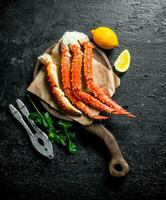 Crabe sur une Coupe planche avec citron et persil. photo