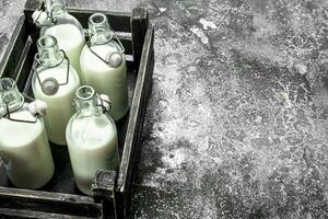 bouteilles de Frais Lait dans un vieux boîte. photo