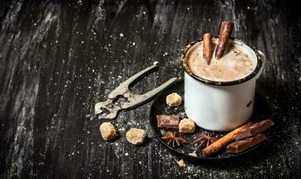 chaud Chocolat avec cannelle et coupeurs pour sucre. photo