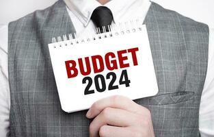 homme d'affaire avec carnet avec texte budget 2024 photo