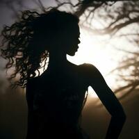 silhouette de une femme avec frisé cheveux permanent dans de face de une arbre génératif ai photo