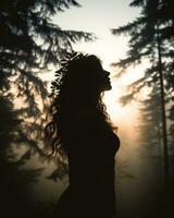 silhouette de une femme dans une forêt à le coucher du soleil génératif ai photo