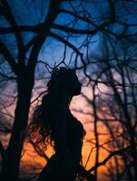 silhouette de une femme dans une forêt à le coucher du soleil génératif ai photo