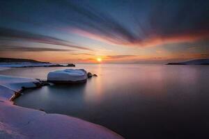 une magnifique le coucher du soleil plus de le océan avec neige couvert rochers. généré par ai photo