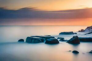 une longue exposition photographier de rochers sur le plage à le coucher du soleil. généré par ai photo