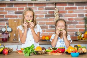 mère et filles cuisine ensemble dans le cuisine. en bonne santé nourriture concept. portrait de content famille avec Frais smoothies. photo