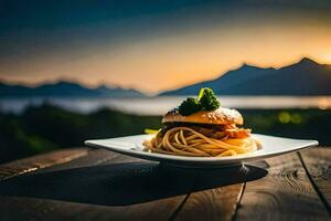 une assiette avec spaghetti et une Burger sur une table dans de face de une le coucher du soleil. généré par ai photo