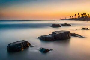 une longue exposition photographier de rochers sur le plage à le coucher du soleil. généré par ai photo