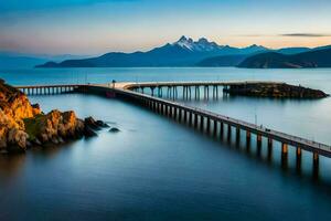 le pont couvrant le océan et montagnes à le coucher du soleil. généré par ai photo