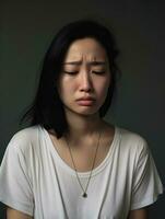 asiatique femme est triste sur une minimaliste neutre Contexte ai génératif photo