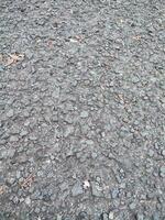 asphalte rugueux et rocheux grunge surface, texture arrière-plan, gris pavé route photo