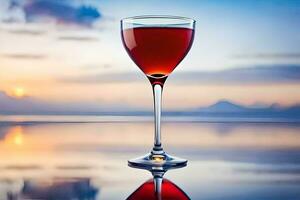 une verre de rouge du vin sur une table dans de face de une le coucher du soleil. généré par ai photo