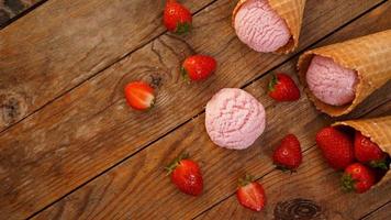 glace à la fraise dans un cornet gaufré. fruits rouges et boules de glace photo