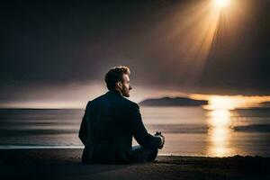 une homme séance sur le plage à le coucher du soleil. généré par ai photo