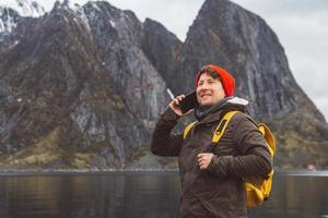 homme parlant au téléphone avec un sac à dos dans la nature photo